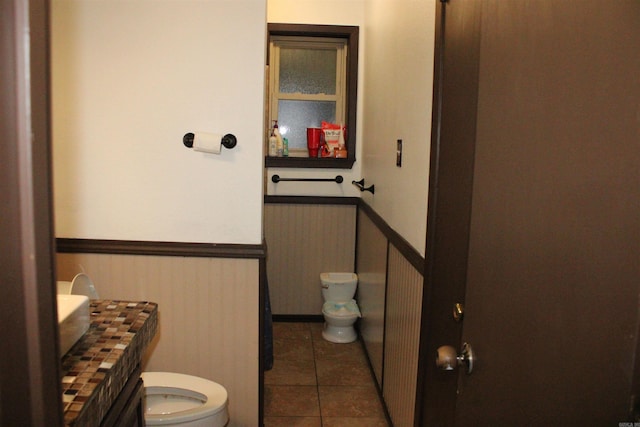 505 Woodland St, Malvern, AR 72104 - bathroom with toilet, wainscoting, tile patterned floors, and vanity
