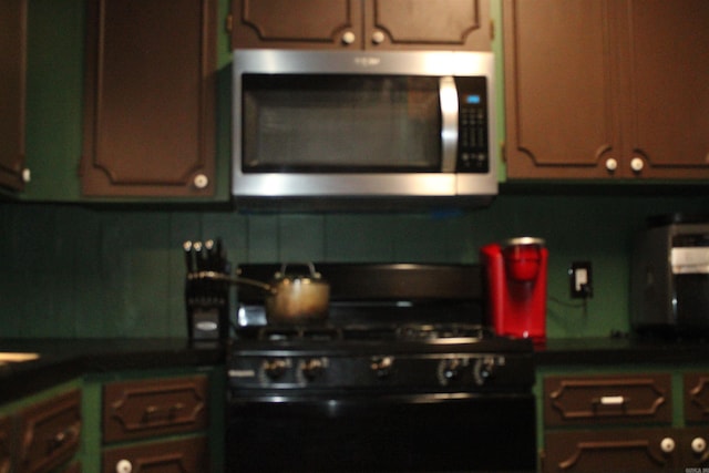 505 Woodland St, Malvern, AR 72104 - kitchen featuring stainless steel microwave, gas stove, and dark countertops
