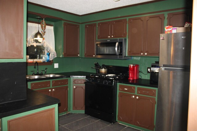 505 Woodland St, Malvern, AR 72104 - kitchen featuring appliances with stainless steel finishes, dark countertops, a sink, and dark tile patterned flooring