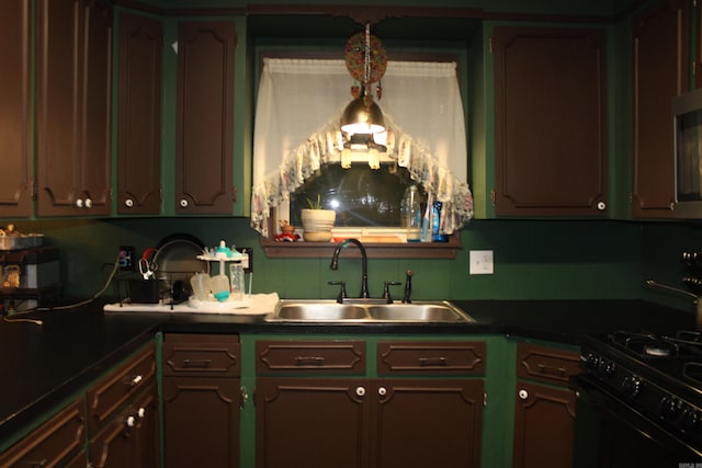 505 Woodland St, Malvern, AR 72104 - kitchen featuring a sink, black gas range oven, and dark countertops