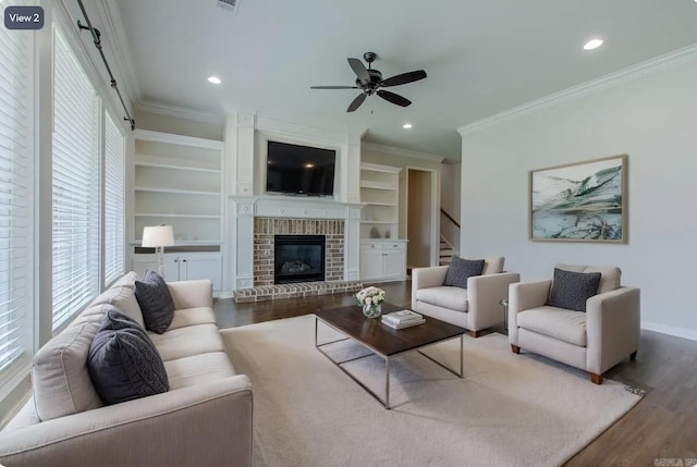 5045 Maple Leaf Dr, Benton, AR 72019 - living room featuring wood finished floors, crown molding, ceiling fan, stairway, and a brick fireplace