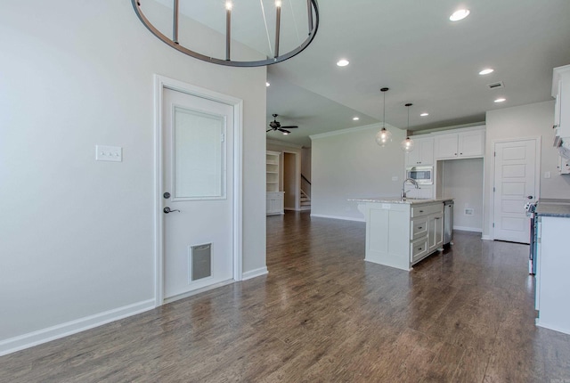 5045 Maple Leaf Dr, Benton, AR 72019 - kitchen with a sink, white cabinetry, open floor plan, baseboards, and recessed lighting