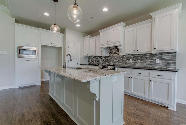 5045 Maple Leaf Dr, Benton, AR 72019 - kitchen with a sink, stainless steel appliances, backsplash, white cabinetry, and recessed lighting