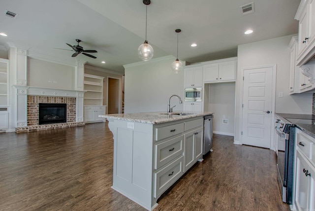 5045 Maple Leaf Dr, Benton, AR 72019 - kitchen with a sink, ornamental molding, appliances with stainless steel finishes, ceiling fan, and white cabinetry