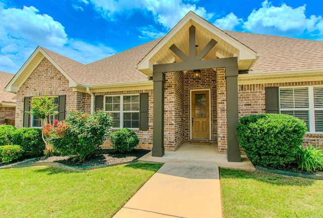 5045 Maple Leaf Dr, Benton, AR 72019 - property entrance with brick siding, roof with shingles, and a lawn