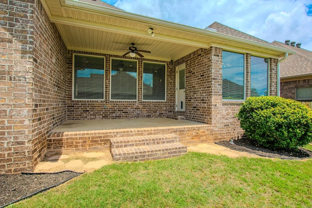 5045 Maple Leaf Dr, Benton, AR 72019 - view of exterior entry with ceiling fan, brick siding, roof with shingles, and a patio