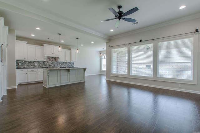 5045 Maple Leaf Dr, Benton, AR 72019 - kitchen with baseboards, tasteful backsplash, white cabinets, dark wood finished floors, and crown molding