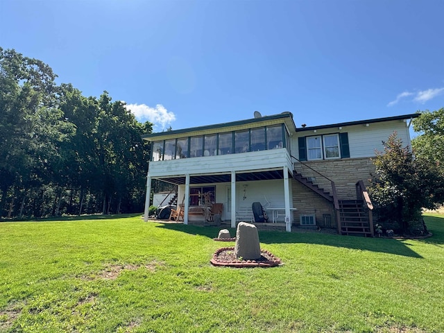 87 Wyandotte Dr, Cherokee Village, AR 72529 - back of property featuring a sunroom, stairs, stone siding, a yard, and a patio