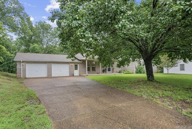 208 Independence Dr, Hot Springs, AR 71913 - view of front of house featuring asphalt driveway, an attached garage, a front lawn, and brick siding