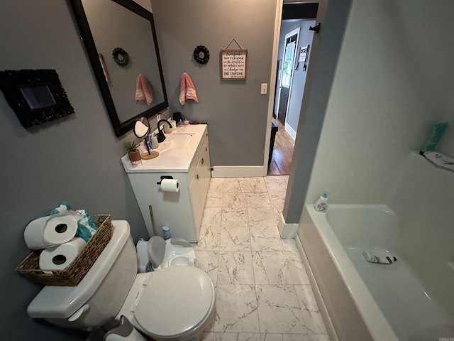 621 W 7th St, Rector, AR 72461 - bathroom with marble finish floors, toilet, vanity, baseboards, and a bath