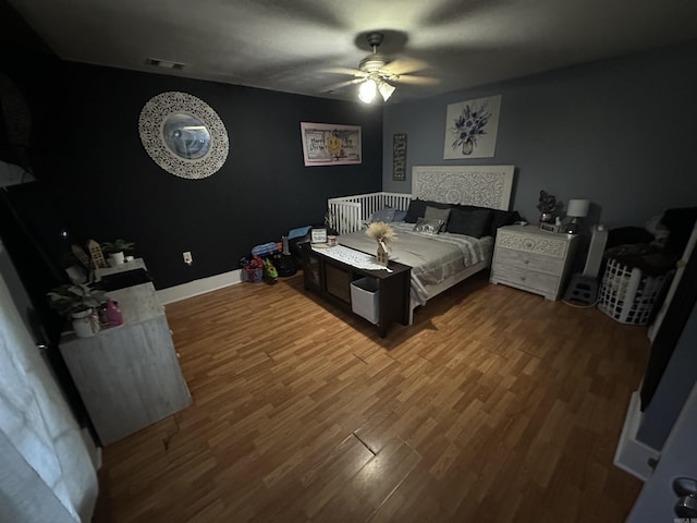 621 W 7th St, Rector, AR 72461 - bedroom featuring wood finished floors, ceiling fan, and baseboards