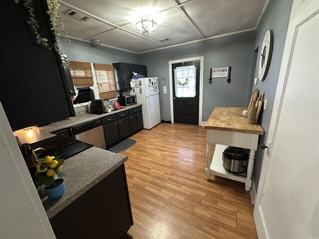 621 W 7th St, Rector, AR 72461 - kitchen with appliances with stainless steel finishes, light wood-style floors, dark cabinets, baseboards, and butcher block countertops