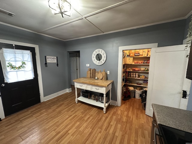 621 W 7th St, Rector, AR 72461 - foyer with light wood finished floors, crown molding, and baseboards