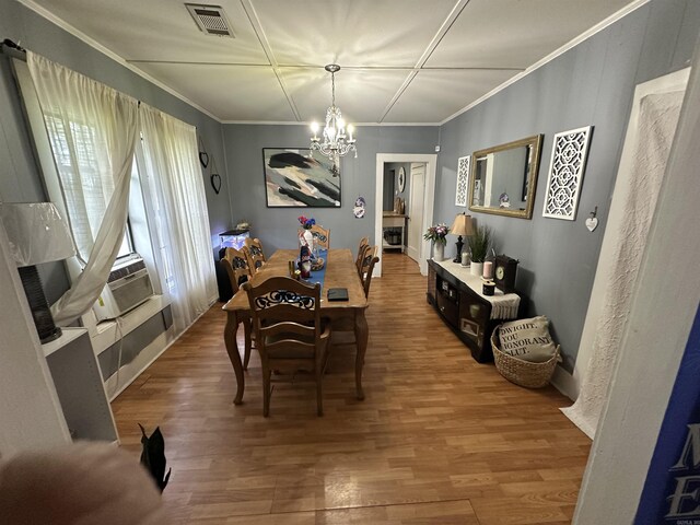 621 W 7th St, Rector, AR 72461 - dining space featuring a chandelier, wood finished floors, and ornamental molding