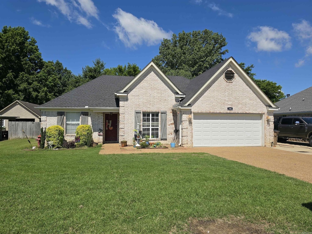 708 Mockingbird Ln, Wynne, AR 72396 - view of front of home with brick siding, concrete driveway, a garage, and a front yard
