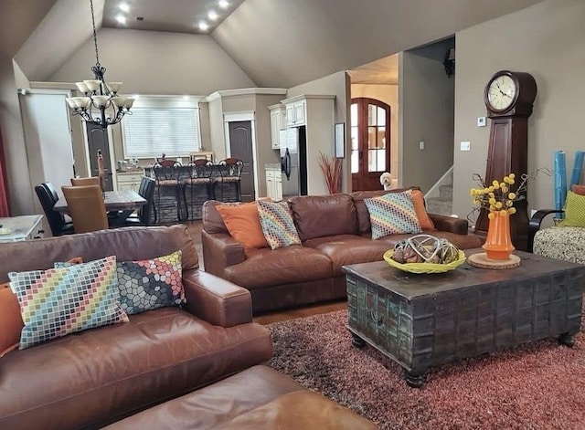 living area featuring a chandelier, stairway, and vaulted ceiling
