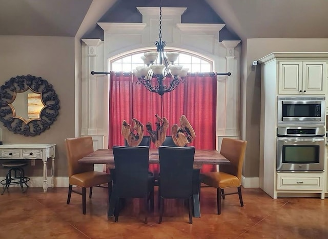 dining space with a chandelier, vaulted ceiling, and tile patterned floors
