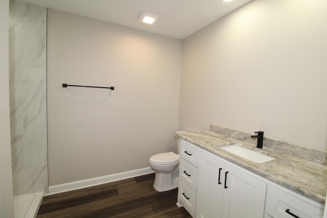 308 N Arch St, Sheridan, AR 72150 - full bath featuring vanity, toilet, a marble finish shower, wood finished floors, and baseboards