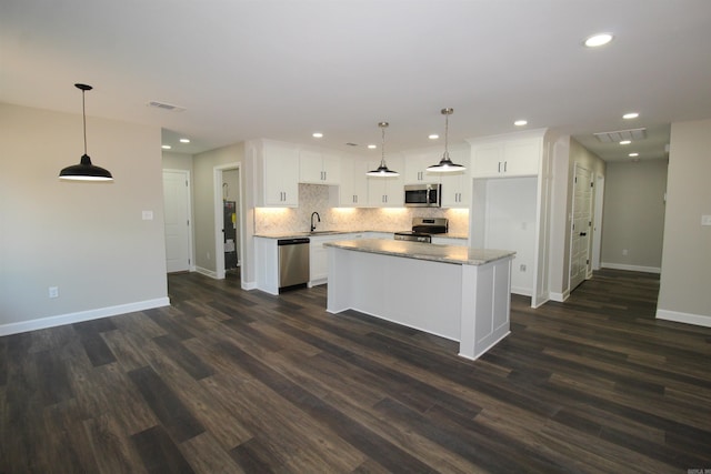 308 N Arch St, Sheridan, AR 72150 - kitchen with stainless steel appliances, baseboards, white cabinets, backsplash, and dark wood-style floors