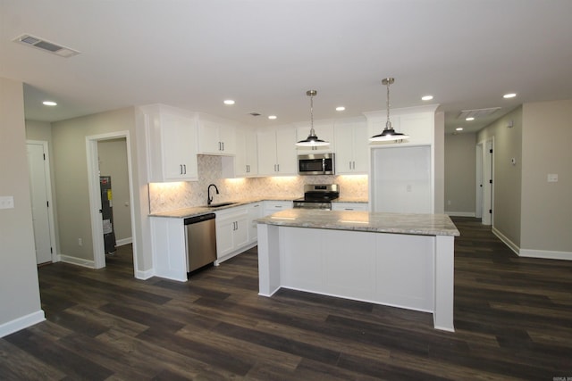 308 N Arch St, Sheridan, AR 72150 - kitchen with stainless steel appliances, a sink, baseboards, decorative backsplash, and white cabinets
