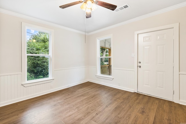2506 W 6th St, Little Rock, AR 72205 - empty room with plenty of natural light, wainscoting, wood finished floors, ceiling fan, and ornamental molding