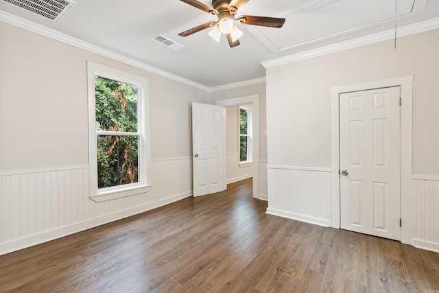 2506 W 6th St, Little Rock, AR 72205 - spare room with attic access, a ceiling fan, wainscoting, wood finished floors, and ornamental molding