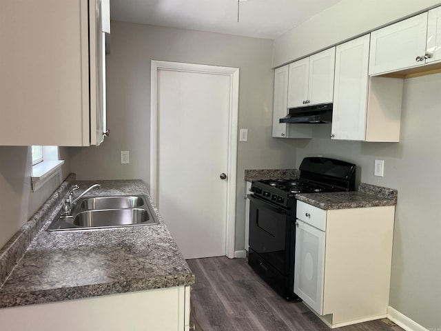 20 Glendale Dr, Little Rock, AR 72209 - kitchen with black gas stove, a sink, under cabinet range hood, dark wood finished floors, and dark countertops