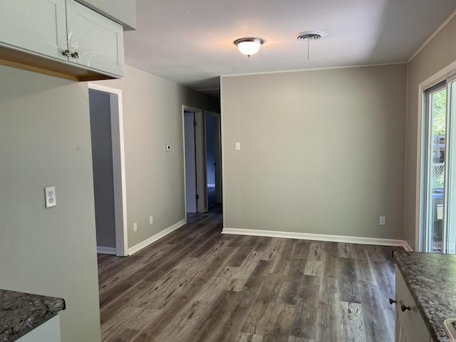 20 Glendale Dr, Little Rock, AR 72209 - unfurnished dining area with dark wood-style flooring and baseboards