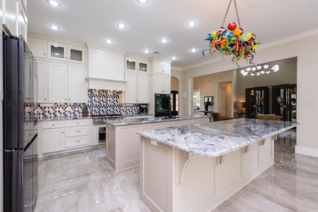20 Accadia Ct, Little Rock, AR 72223 - kitchen with a kitchen island, black appliances, crown molding, backsplash, and light marble finish floors