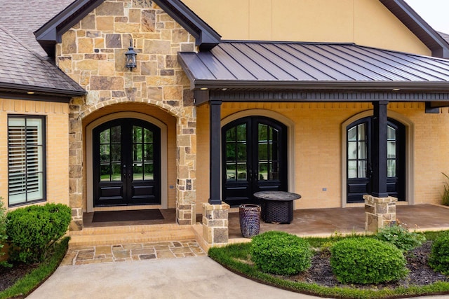 20 Accadia Ct, Little Rock, AR 72223 - property entrance featuring french doors, a standing seam roof, brick siding, and metal roof