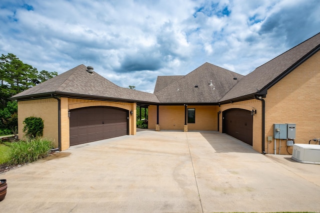 20 Accadia Ct, Little Rock, AR 72223 - view of front of property with an attached garage, concrete driveway, brick siding, and roof with shingles