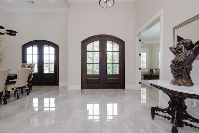 20 Accadia Ct, Little Rock, AR 72223 - entryway with french doors, arched walkways, a towering ceiling, light marble finish flooring, and crown molding