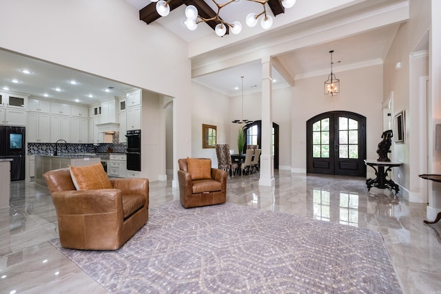 20 Accadia Ct, Little Rock, AR 72223 - living area with a towering ceiling, light marble finish floors, french doors, a chandelier, and ornamental molding