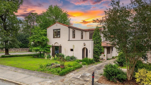 1729 N Spruce, Little Rock, AR 72207 - mediterranean / spanish home featuring stucco siding, a front lawn, and a tiled roof
