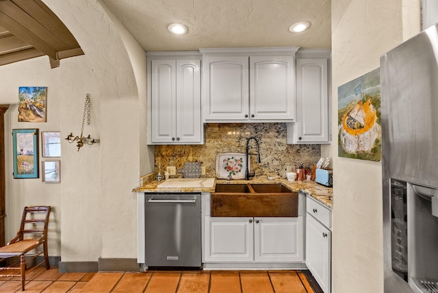 1729 N Spruce, Little Rock, AR 72207 - kitchen with stainless steel appliances, backsplash, light tile patterned floors, a sink, and white cabinetry