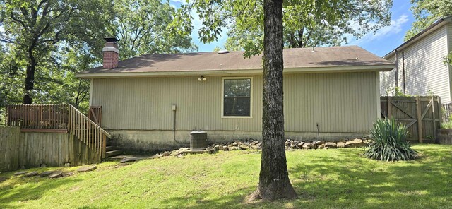 203 Creekwood Dr, Jacksonville, AR 72076 - back of house featuring a chimney and cooling unit