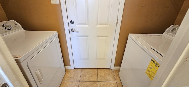 203 Creekwood Dr, Jacksonville, AR 72076 - laundry room featuring washer and clothes dryer, light tile patterned floors, and baseboards