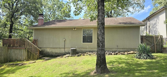 203 Creekwood Dr, Jacksonville, AR 72076 - back of house featuring a chimney and cooling unit