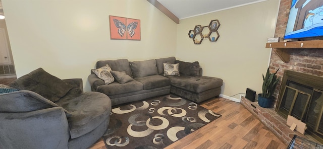 203 Creekwood Dr, Jacksonville, AR 72076 - living area with wood finished floors, a brick fireplace, ornamental molding, and baseboards