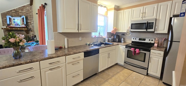 203 Creekwood Dr, Jacksonville, AR 72076 - kitchen with stainless steel appliances, a sink, light tile patterned floors, white cabinets, and backsplash