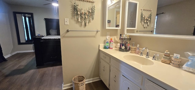 203 Creekwood Dr, Jacksonville, AR 72076 - bathroom with wood finished floors, vanity, and baseboards