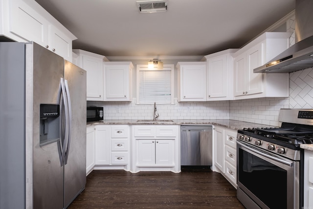 708 N Taylor St, Little Rock, AR 72205 - kitchen with appliances with stainless steel finishes, a sink, wall chimney range hood, white cabinetry, and dark wood-type flooring