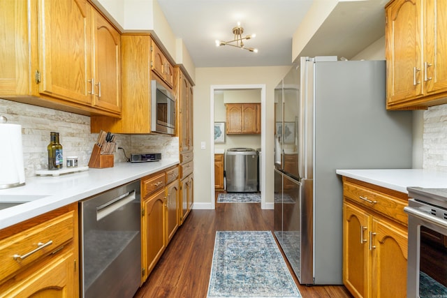 kitchen with appliances with stainless steel finishes, tasteful backsplash, and brown cabinets