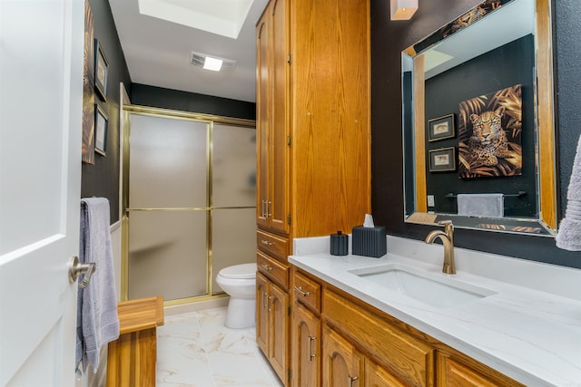 full bathroom with vanity, toilet, marble finish flooring, and a shower stall
