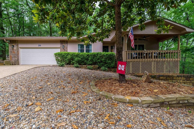 view of front of property featuring ceiling fan, driveway, an attached garage, and covered porch