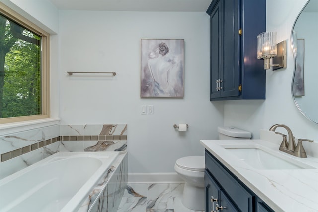 full bathroom with marble finish floors, vanity, a garden tub, toilet, and baseboards