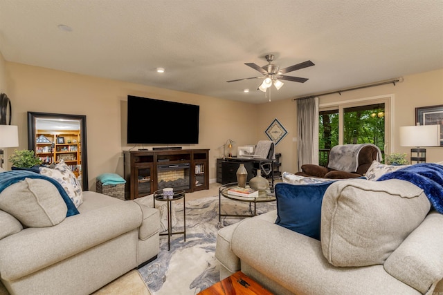 living area with a ceiling fan and recessed lighting