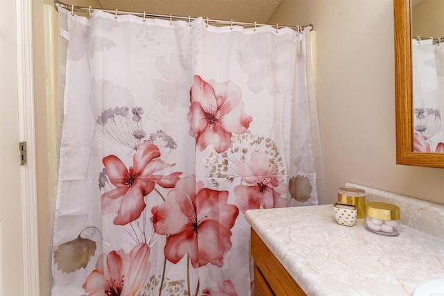 bathroom with vanity and curtained shower