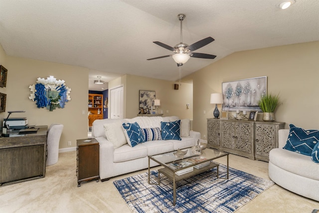 living room featuring carpet floors, ceiling fan, lofted ceiling, and baseboards