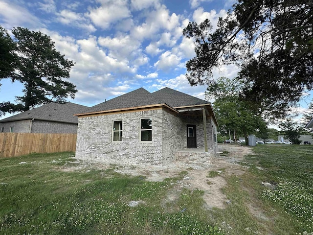 412 N 3rd St, Cabot, AR 72023 - view of side of home featuring brick siding and roof with shingles